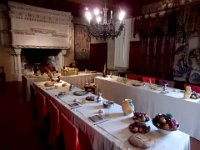 Medievel eating at Chateau de Langeais  Wineglasses and soup bowls are shared.  Simple trenchers used as plates