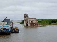 Church isolated by flooding due to dams  Seems to be a dredging operation